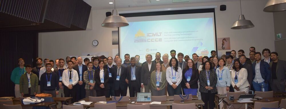 Group photo of ICMLT 2025 and CCCE 2025 attendees in the conference room in Helsinki.